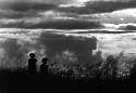 Samuel Putnam negatives, New Guinea; 2 men; late in the evening of the battle between the WW and Wittaia out on the end of the Warabara; they are silhouettes against the the sky