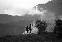 Samuel Putnam negatives, New Guinea; 2 men remain on the high knoll in the Warabara