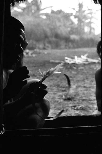 Samuel Putnam negatives, New Guinea; in the honai in Abulupak; men making a kara kara