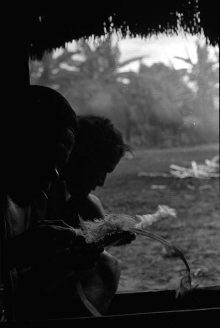Samuel Putnam negatives, New Guinea; in the honai in Abulupak; men making a kara kara