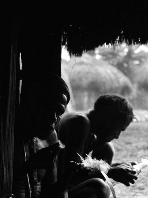 Samuel Putnam negatives, New Guinea; in the honai in Abulupak; men making a kara kara