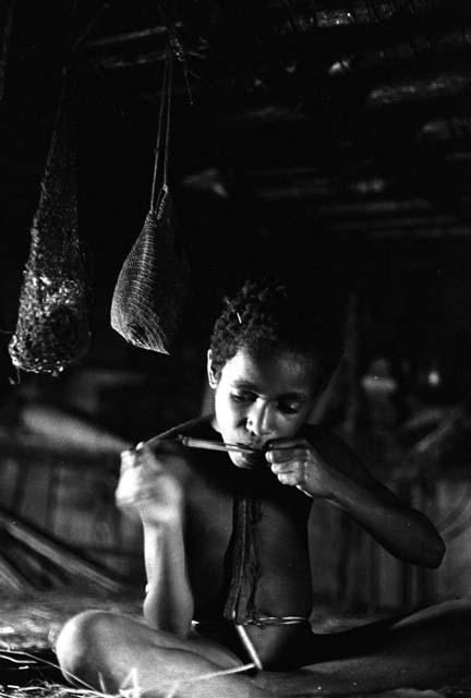 Samuel Putnam negatives, New Guinea; Uwar playing a picon inside a honai