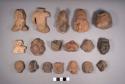 18 pottery body parts: 16 human head effigies, 2 torso effigies