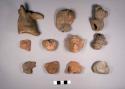 26 miscellaneous pottery head effigies (3 human, 23 animal)