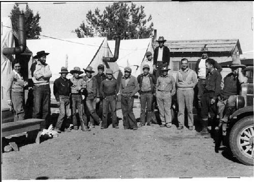 Group of people standing in front of tents at Awatovi