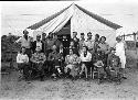 Group of people sitting in front of tent at Awatovi