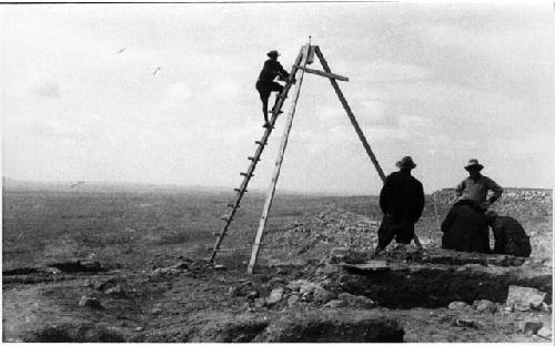 Group of men with a tripod