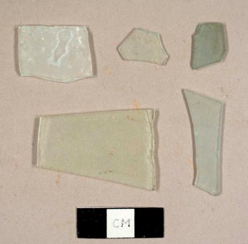 Colorless flat glass fragments, possibly frosted