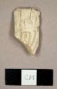 White kaolin pipe bowl fragment with molded decorations