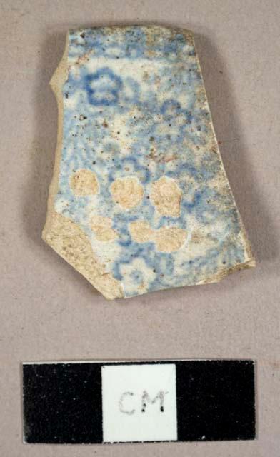 Whiteware rim sherd to a plate with blue and white transfer print, burned