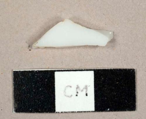 Opaque white bottle glass fragment