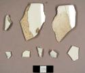 Ironstone and whiteware sherds, including two cup rim sherds that mend together and a possible plate rim sherd