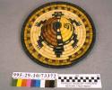 Coiled circular plaque with raised turtle motif