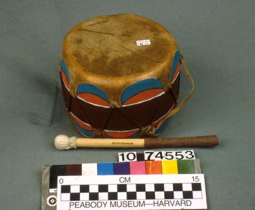 Small painted wooden drum (A) with beater (B)