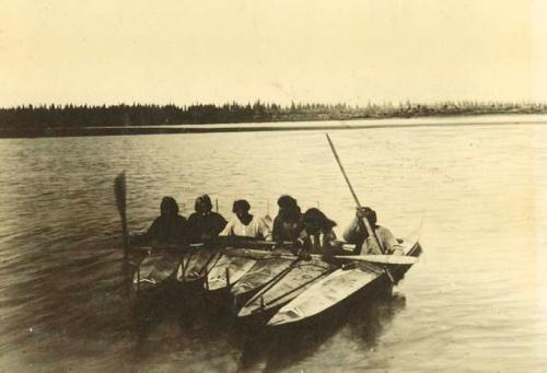 Six Inuit men in kayaks