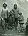 Two Inuit men standing with three children