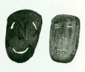 Front view of two carved wooden masks.