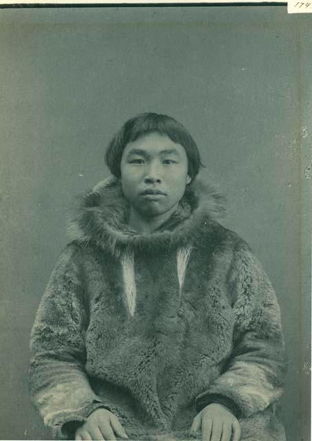 Inuit boy wearing fur parka
