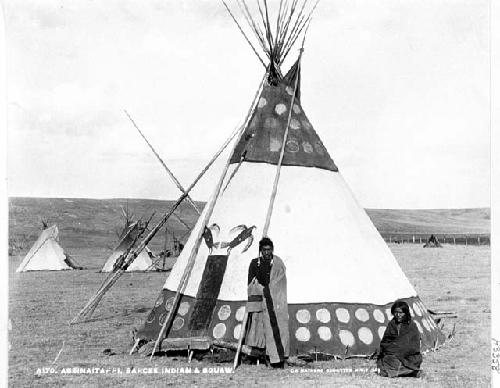 Man and woman in front of tepee