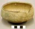 Ceramic vessel, incised body & rim, mended, rim sherds missing.