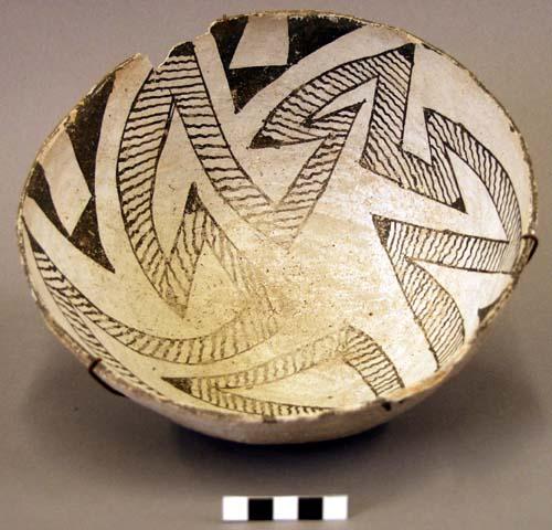 Bowl, black on grey geometric design, rim sherds missing, wire suspension system