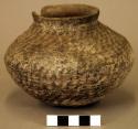 Jar, corrugated plain ware, filled with bone (cranium?)