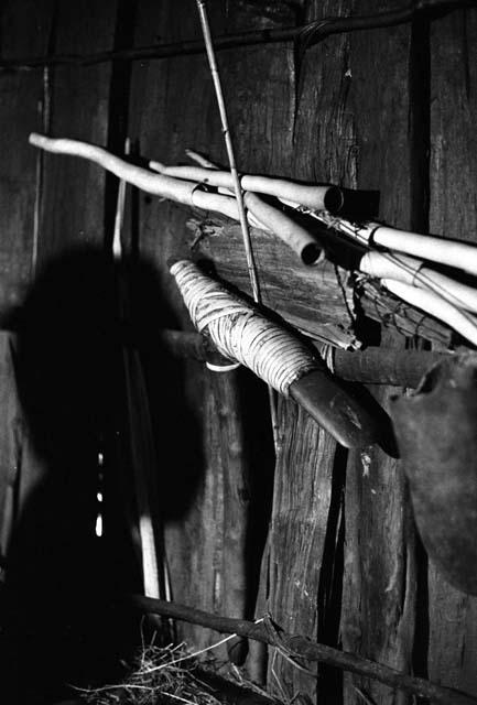 Samuel Putnam negatives, New Guinea; Uwar's shadow against the wall; a stone axe hanging against the wall of the honai