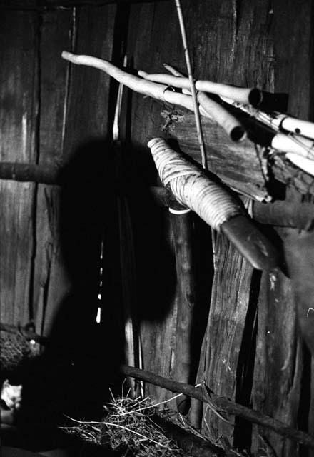 Samuel Putnam negatives, New Guinea; Uwar's shadow against the wall; a stone axe hanging against the wall of the honai