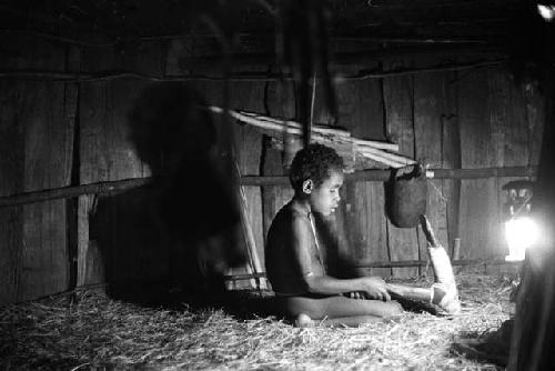 Samuel Putnam negatives, New Guinea; Uwar looking at a huge stone axe of Weaklekek