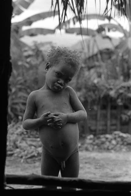 Samuel Putnam negatives, New Guinea; a small boy in Wuperainma; it is Yege Asuk's son; seen thru the door of the hunu