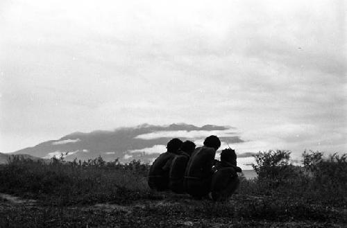 Samuel Putnam negatives, New Guinea; 4 figures seated; looking toward the north in the evening