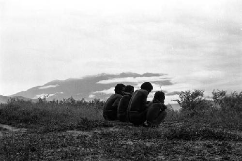 Samuel Putnam negatives, New Guinea; 4 figures seated; looking toward the north in the evening