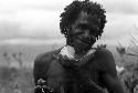Samuel Putnam negatives, New Guinea; Eterhebelek models his mikak under his chin; the mikak was given to him by the expedition as an offering for his son's death
