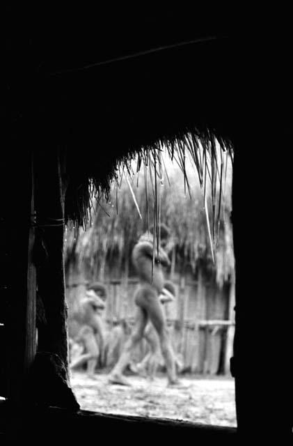 Samuel Putnam negatives, New Guinea; shot thru the hunu doorway; figures out of focus