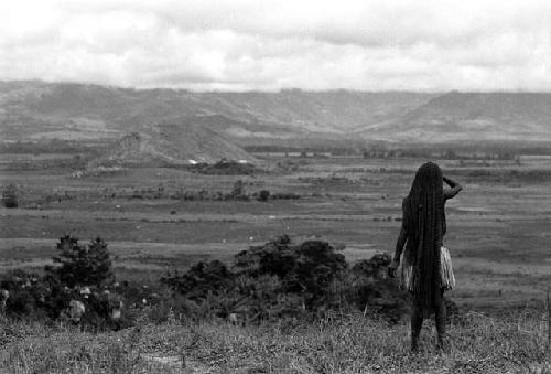 Samuel Putnam negatives, New Guinea; woman looking out over the valley from Abukulmo gardens