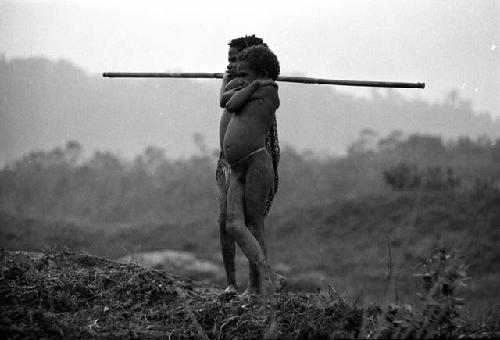 Samuel Putnam negatives, New Guinea; Yege Abu and a little girl standing above Homaklep watching their pigs