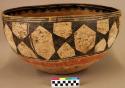 Very large pottery bowl, slight irregular. Red base, greyish slip with black de