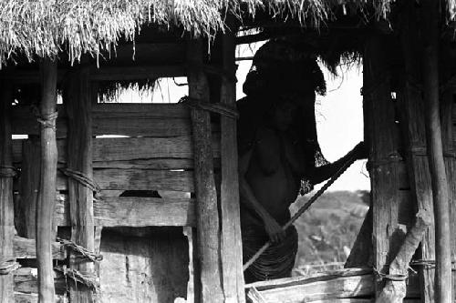 Samuel Putnam negatives, New Guinea; woman leaving sili