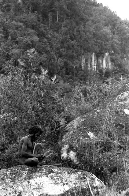 Samuel Putnam negatives, New Guinea; Eterhebelek sitting on a rock near Lokoparek