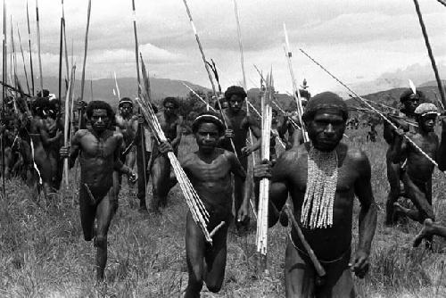 Samuel Putnam negatives, New Guinea; warriors racing up to join the battle on the Tokolik