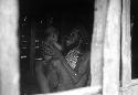 Samuel Putnam negatives, New Guinea; Wali smiles at his baby; seen thru the hunu door