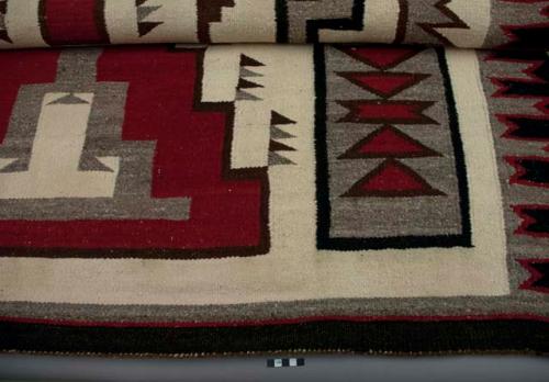 Navajo rug with geometric design; gray, black, red and white wool