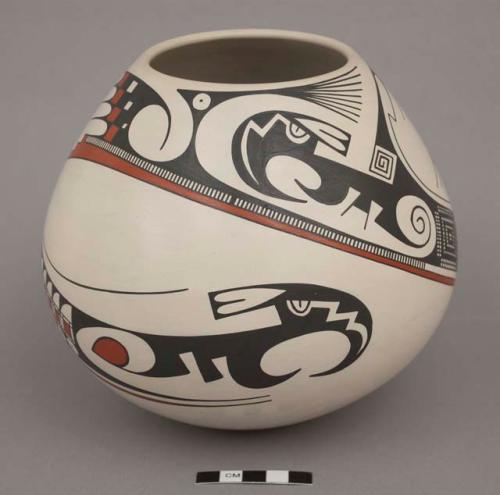 Pot; black and orange encircling design on white ground; rounded bottom; signed on bottom