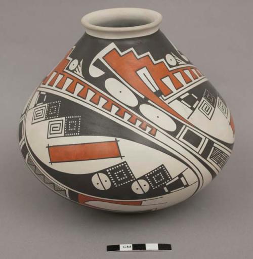 Jar; black and orange encircling design on white ground; rounded bottom; signed on bottom