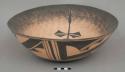 Large red dough bowl; black pattern on exterior; spongeware interior with two black dragonflies and two black tadpoles; signed Marcus Homer / Zuni, NM '97 with bear paw imprint