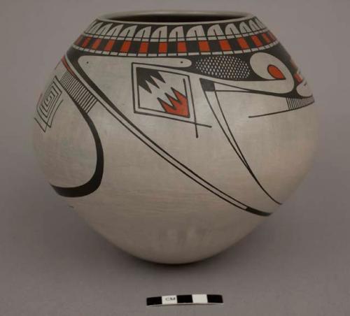 Pot; black and orange encircling design on gray ground; convex bottom