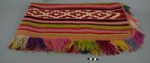 Poncho; red, yellow, green, white, black and brown stripes; stepped design; fringe