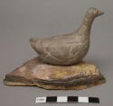 Carved stone sitting goose; broken and repaired