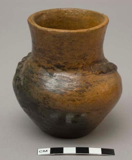 Pot with two applied, pinched design elements at shoulder; pine pitch; signed L.R.G.