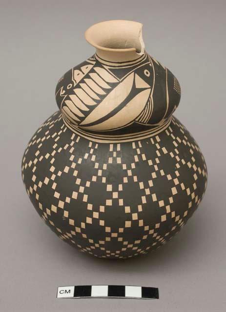 Buff clay vase with a waist; fish and bird design on upper segment; large chip at rim